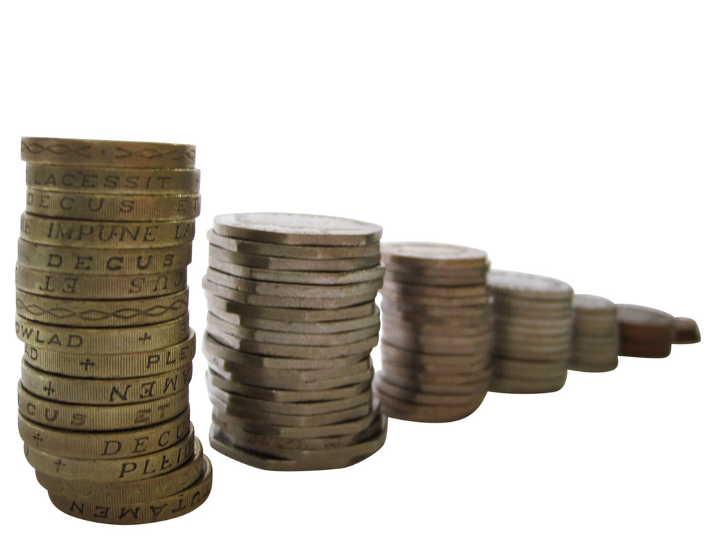 Stacks of coins representing steady saving toward an emergency fund