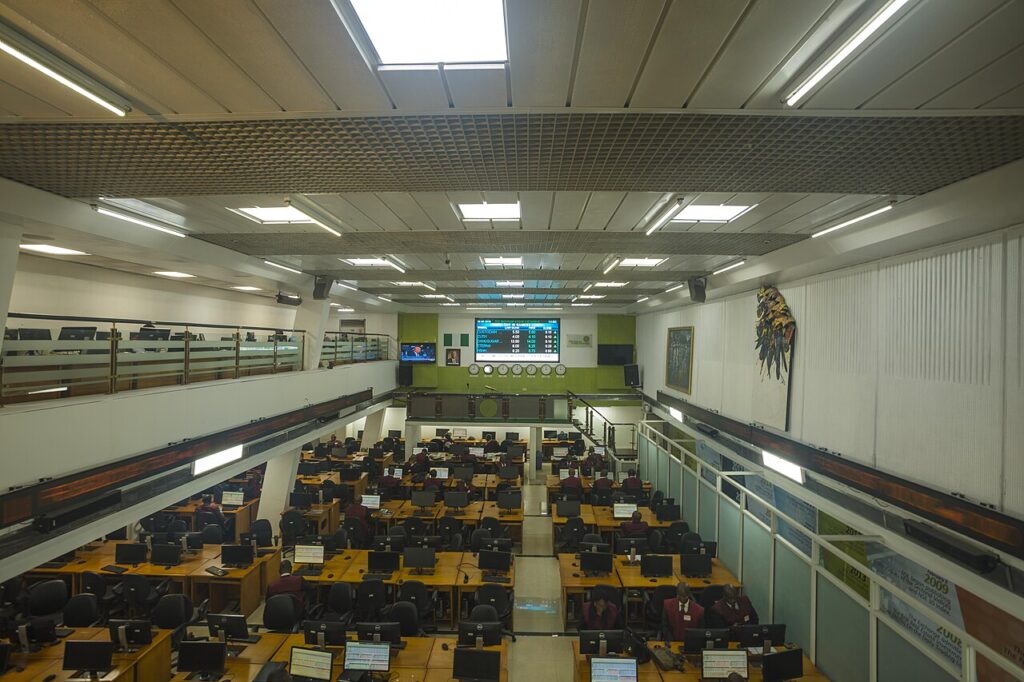 Busy stock exchange trading floor with electronic quotation boards